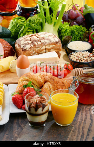 Composition with variety of organic food products on kitchen table Stock Photo