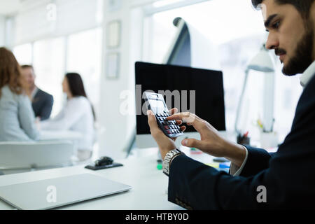 Accountant checking statistics of company profit on calculator Stock Photo