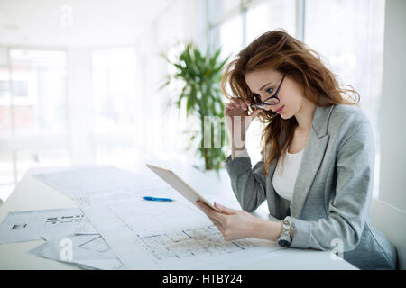 Beautiful female architect working in company office Stock Photo