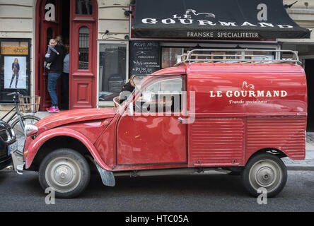 Red citroen 2cv van outside Le Gourmand on Værnedamsvej a lively shopping street n Vesterbro, Copenhagen, Denmark Stock Photo