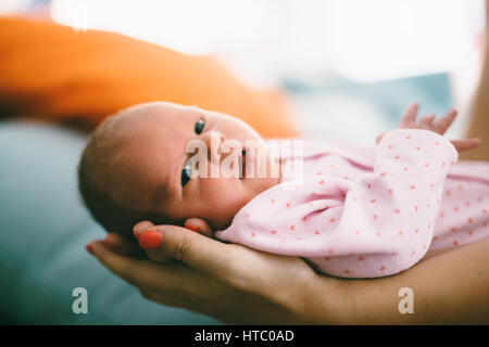Mother proudly holding beautiful little newborn Stock Photo