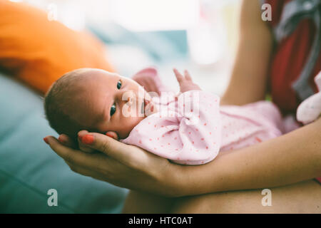 Mother proudly holding beautiful little newborn Stock Photo