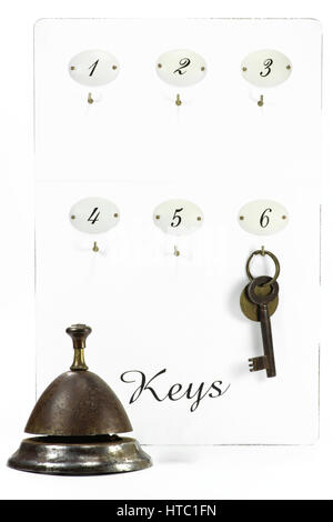 vintage hotel key at keyboard with service bell Stock Photo