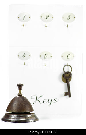 vintage hotel key at keyboard with service bell Stock Photo