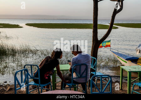 An Ethiopian Couple Sitting At A Lakeside Cafe, Lake Awassa, Ethiopia Stock Photo