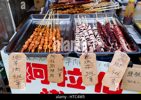 Grilled meat and octopus skewers at a stall in the Tai O fishing village, Lantau Island, Hong Kong, China. Stock Photo