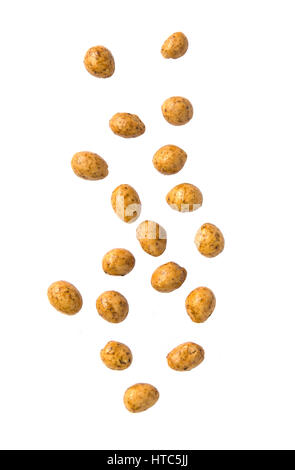 Roasted peanuts coated falling on white background. Stock Photo