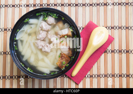 Pork noodle soup on wooden table. Stock Photo