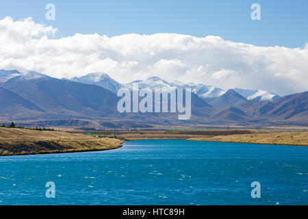 Twizel, Canterbury, New Zealand. View along the Pukaki Canal to the snow-dusted summits of the Ben Ohau Range. Stock Photo