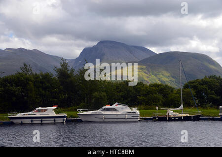 Pleasure Boats and the Munros Anoach Mor, Carn Mor Dearg & Ben Nevis from the Caladonian Canal near Fort William in the Scottish Highlands. Stock Photo