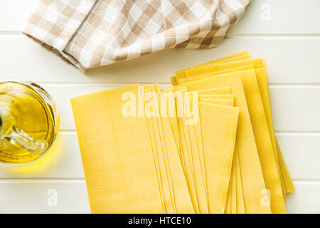 Raw lasagne sheets on white table. Stock Photo