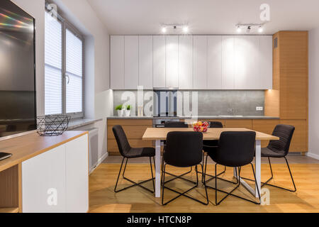 Dining table and chairs in modern, bright and open kitchen Stock Photo