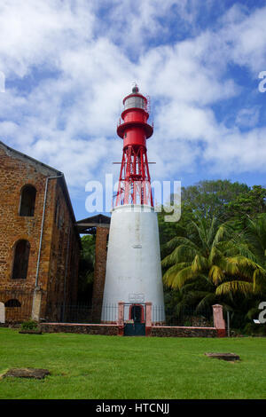 A lighthouse still stands among the ruined buildings of the old French prison on Devil's Island. This lighthouse, built in the 1930's is still in use Stock Photo