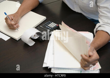 Man doing accounts Stock Photo
