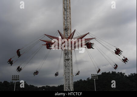 14.08.2012, Pyongyang, North Korea - Visitors enjoy the ride on a chairoplane at the Kaeson funfair in the North Korean capital Pyongyang. Stock Photo