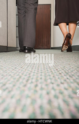 Two colleagues walking along corridor Stock Photo