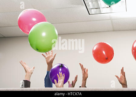 Office workers playing with balloons Stock Photo