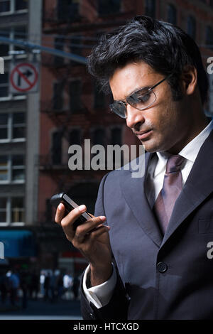 Businessman reading a text message Stock Photo