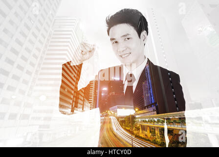 Double exposure of winning businessman against the city Stock Photo
