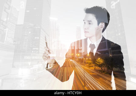 Double exposure of  business man thinking against the city Stock Photo