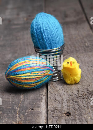 Two Easter eggs covered with wool yarn on a rutsic wooden table Stock Photo
