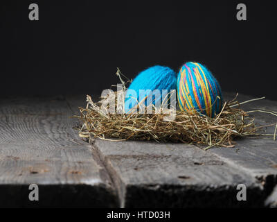 Two Easter eggs in a nest on a wooden table Stock Photo