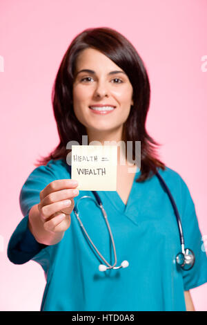 Female nurse holding an adhesive note Stock Photo