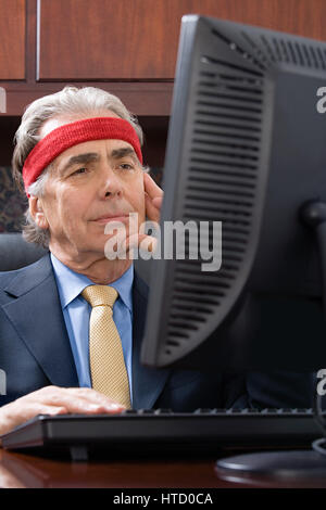 Businessman wearing a sweatband Stock Photo