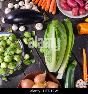 Organic vegetables on dark wooden board. View from above Stock Photo