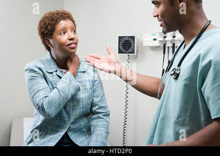 Woman talking to doctor Stock Photo