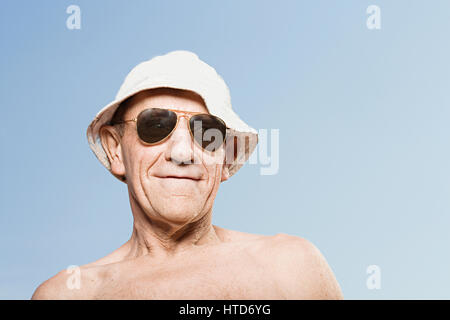 Man wearing a sunhat and sunglasses Stock Photo