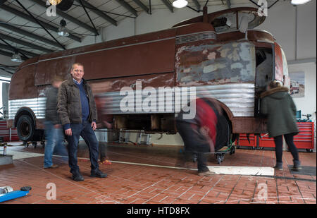 Ilmenau, Germany. 21st Feb, 2017. The new owner Marek Schramm stands next to his GM Futurliner show truck at a restoration shop in Ilmenau, Germany, 21 February 2017. 12 of these limited General Motors show trucks used to present the technology of the future in the US 70 years ago. This truck was said to be lost. Photo: Arifoto Ug/dpa-Zentralbild/dpa/Alamy Live News Stock Photo