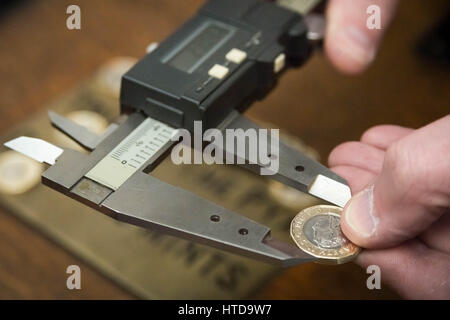 London, UK. 9th Mar, 2017. New £1 coins tested in the London Assay office ahead of their release 28th March, 2017. Pictured: One of the new 12 sided pound coins being measured by a Micrometer. This measures the diameter. It should be 23mm or within a certain tolerance of that. Credit: Guy Corbishley/Alamy Live News Stock Photo