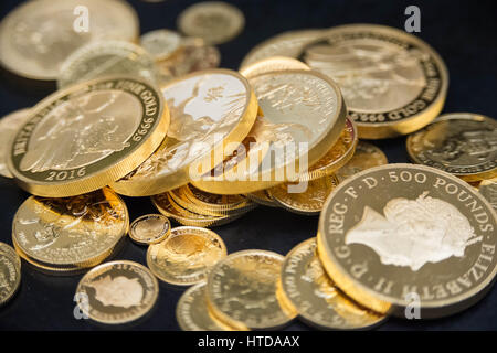 As well as standard 20p, 50p, £1, and £2 coins, the London Assay office also tests commemorative coins in their Laboratory at The Goldsmiths' Company Assay Office. Seen here a mix of gold proof sovereign coins. Stock Photo