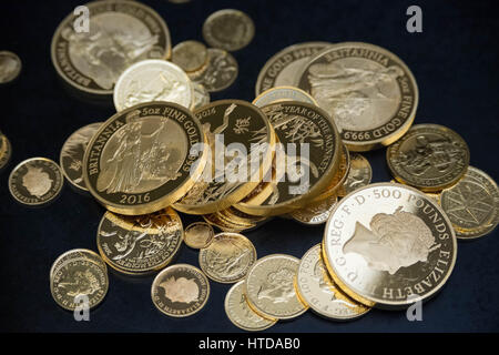 As well as standard 20p, 50p, £1, and £2 coins, the London Assay office also tests commemorative coins in their Laboratory at The Goldsmiths' Company Assay Office. Seen here a mix of gold proof sovereign coins. Stock Photo