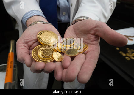 London, UK. 9th Mar, 2017. As well as standard 20p, 50p, £1, and £2 coins, the London Assay office also tests commemorative coins. Chris Walne, the Laboratory Manager, at The Goldsmiths' Company Assay Office, holds here a mix of gold proof sovereign coins. Credit: Guy Corbishley/Alamy Live News Stock Photo