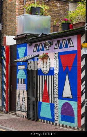 Shoreditch - colourful mural graffiti of shapes on wall of building with roof garden at Shoreditch, London in September Stock Photo