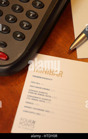 Hotel room mini bar menu with phone and pen Stock Photo - Alamy