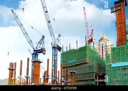 Blue sky background in the construction site and many cranes Stock Photo