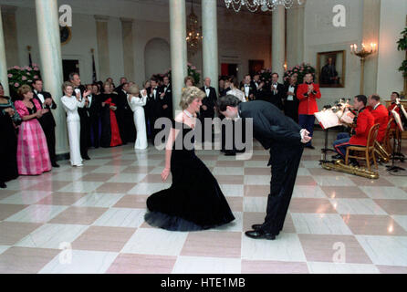 Princess Diana dances with John Travolta in the Cross Hall of the White House in Washington, D.C at a Dinner for Prince Charles and Princess Diana of the United Kingdom on November 9, 1985 Mandatory Stock Photo