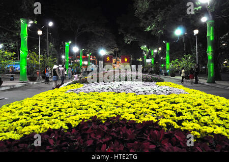 HO CHI MINH - FEB 15: A group of unidentified citizens enjoying the Tet Lunar New Year celebrations in the Central Park of the Communism in Saigon. On Stock Photo