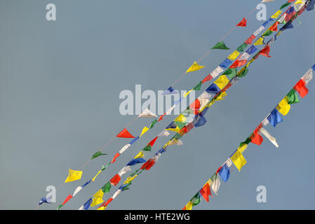 Buddhist Tibetan prayer flags blowing in the wind Stock Photo