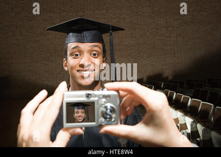Male graduate having his photograph taken Stock Photo