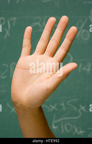 Student with hand raised Stock Photo