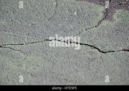 Cracks in tarmac road surface. Stock Photo