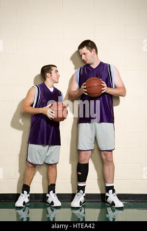 Tall and short basketball players Stock Photo