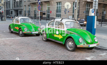 Two green antique car standing on the street Stock Photo