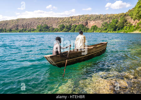 Africans in canoe, Chala lake, border Kenya and Tanzania Stock Photo