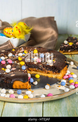 Chocolate and salted caramel Easter tart garnished with mini chocolate eggs Stock Photo