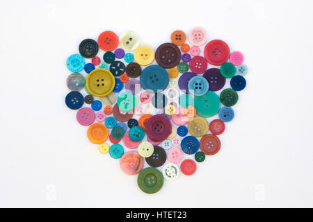 Assortment of colourful Buttons shaped as a heart on white background Stock Photo